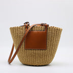 Large structured brown woven straw bag with an adjustable crossbody strap