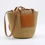 Large structured brown woven straw bag with an adjustable crossbody strap