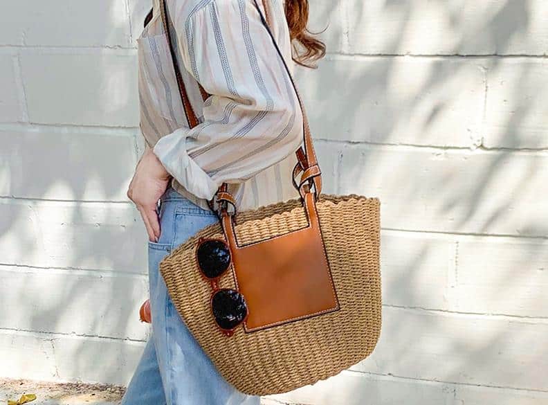 Large structured brown woven straw bag with an adjustable crossbody strap
