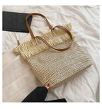 Large white woven straw shoulder bag with fringe trim