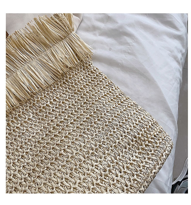 Large white woven straw shoulder bag with fringe trim
