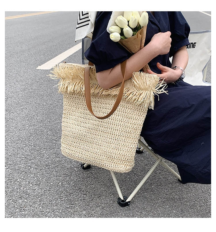 Large white woven straw shoulder bag with fringe trim