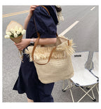 Large white woven straw shoulder bag with fringe trim