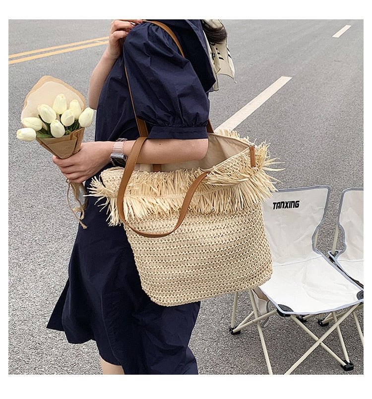 Large white woven straw shoulder bag with fringe trim