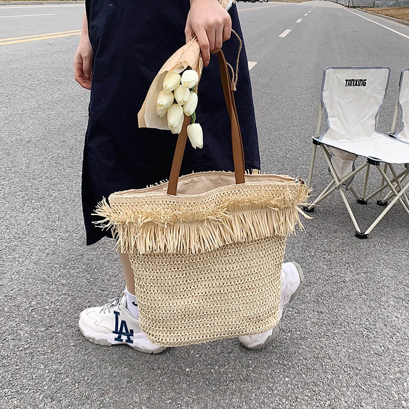 Large white woven straw shoulder bag with fringe trim