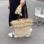 Large white woven straw shoulder bag with fringe trim