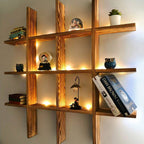 Large wooden grid wall shelf displaying books and collectibles