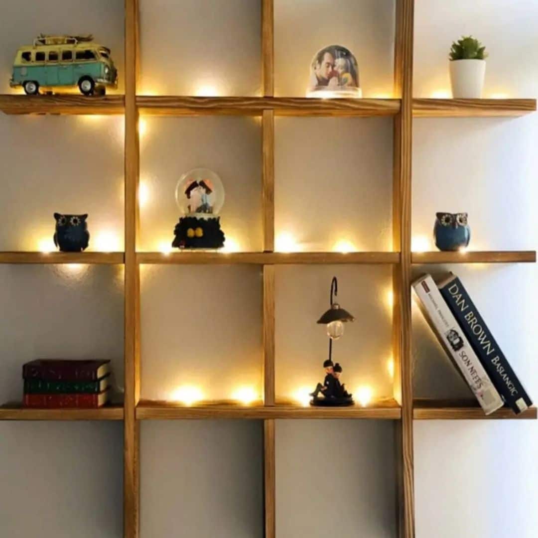 Large wooden grid wall shelf displaying books and collectibles
