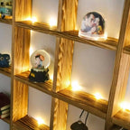Large wooden grid wall shelf displaying books and collectibles
