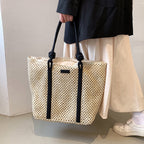 Large structured woven straw tote with sturdy handles and a fabric lining