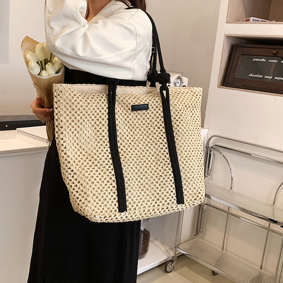 Large structured woven straw tote with sturdy handles and a fabric lining