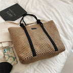 Large structured woven straw tote with sturdy handles and a fabric lining