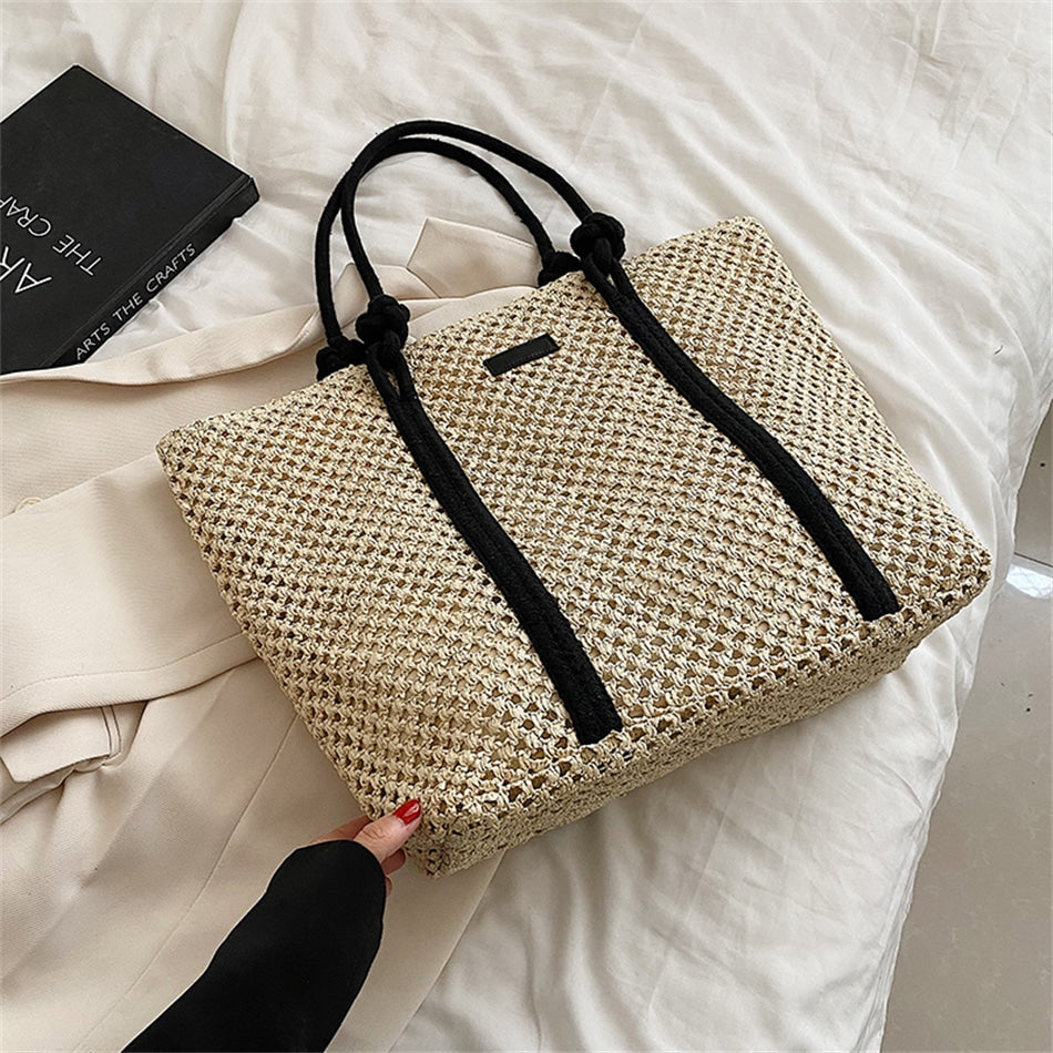 Large structured woven straw tote with sturdy handles and a fabric lining