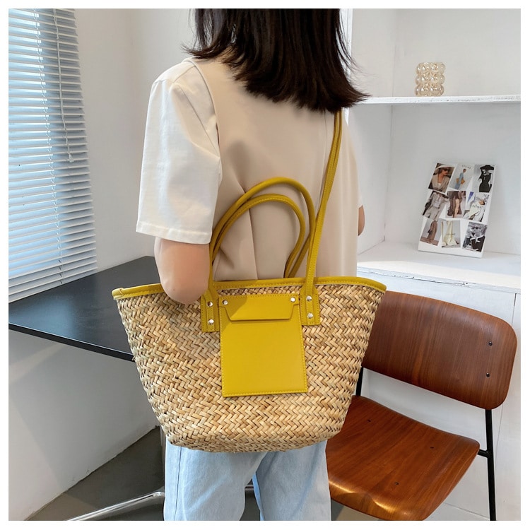 Large sunny yellow hand woven straw summer bag with two sturdy handles