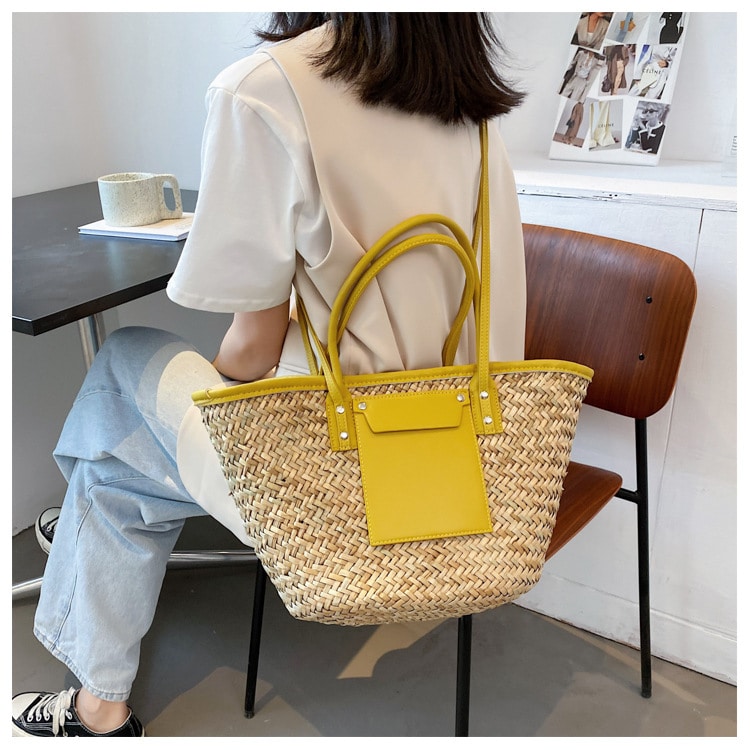 Large sunny yellow hand woven straw summer bag with two sturdy handles