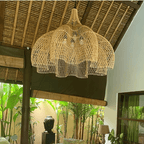 Large layered openwork rattan dome chandelier under a wooden roof