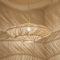 Wide layered rattan saucer pendant casting shadows on the ceiling