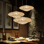 Wide layered rattan saucer pendant casting shadows on the ceiling