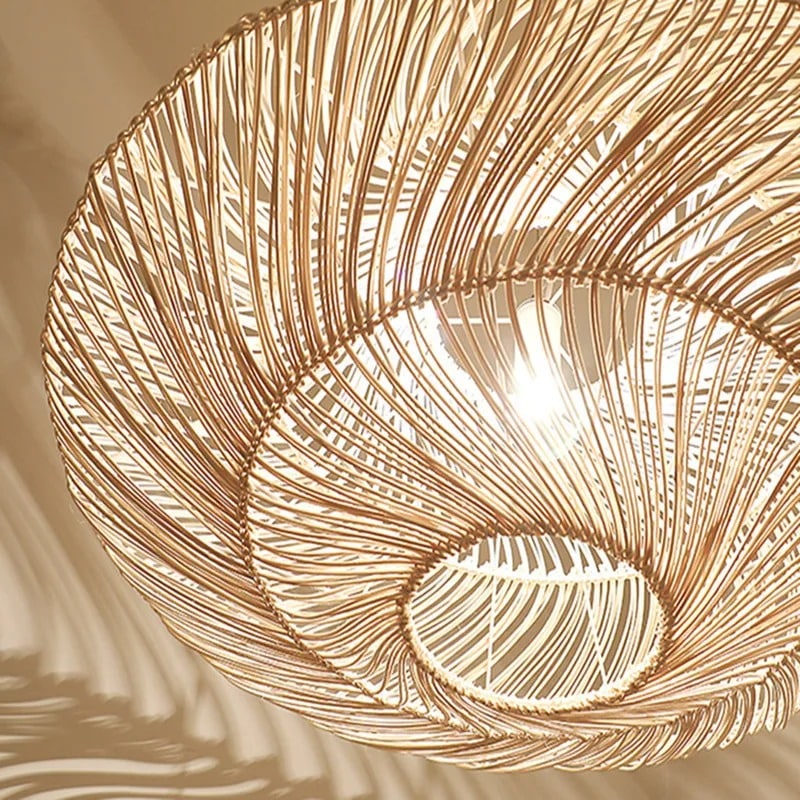 Wide layered rattan saucer pendant casting shadows on the ceiling