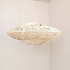 Wide layered rattan saucer pendant casting shadows on the ceiling