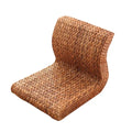 Brown legless floor chair on a curved hand woven rattan base