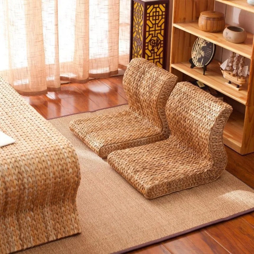Brown legless floor chair on a curved hand woven rattan base
