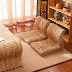 Brown legless floor chair on a curved hand woven rattan base
