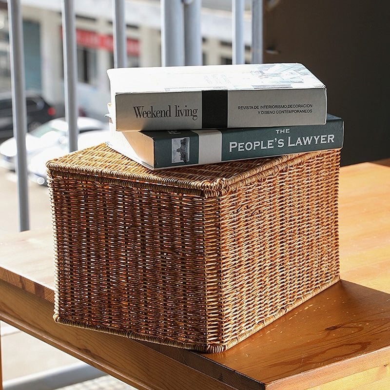 Rectangular woven storage basket with open lid holding papers