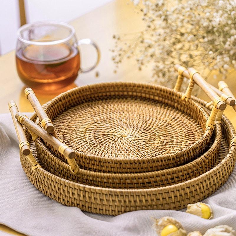 Round light beige rattan tray with wooden dowel handles