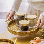 Round light beige rattan tray with wooden dowel handles