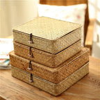 Low flat storage box hand woven in light natural rattan with a lid