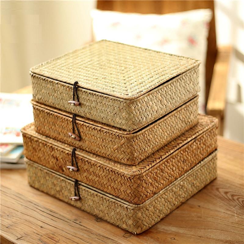 Low flat storage box hand woven in light natural rattan with a lid