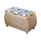 Light woven storage stool with a white and black floral padded lid on turned wood feet