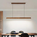Slim linear chandelier in brown wood with an integrated LED strip