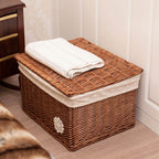 Small woven rattan toy box with a fabric lining and lace trim