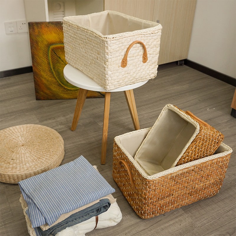 Lined woven storage boxes with handles on shelves