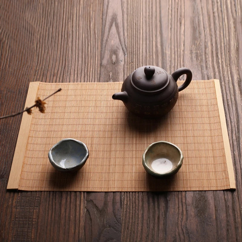 Long honey toned woven bamboo table runner in a Japanese style