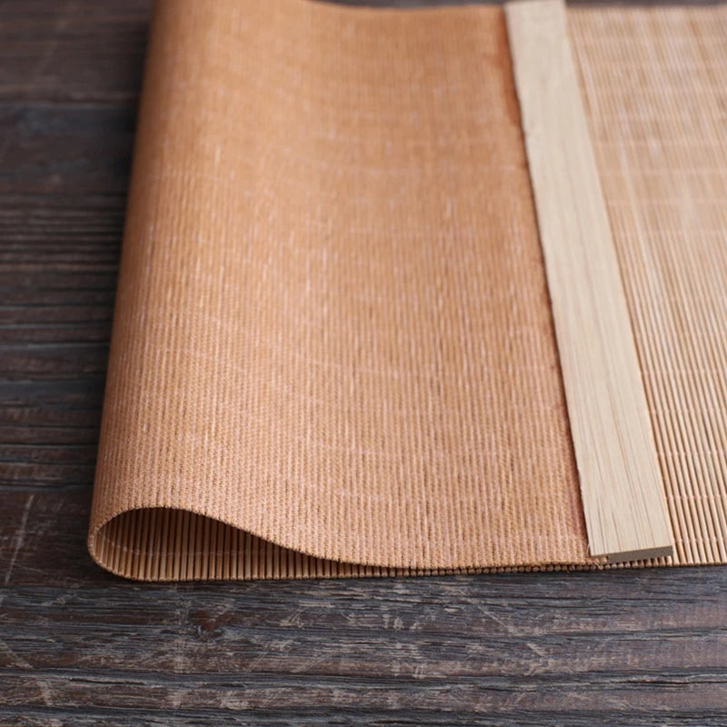 Long honey toned woven bamboo table runner in a Japanese style