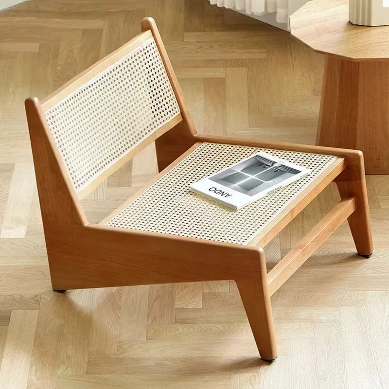 Low enveloping Nordic chair hand woven in natural beige wicker
