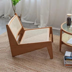 Low enveloping Nordic chair hand woven in natural beige wicker