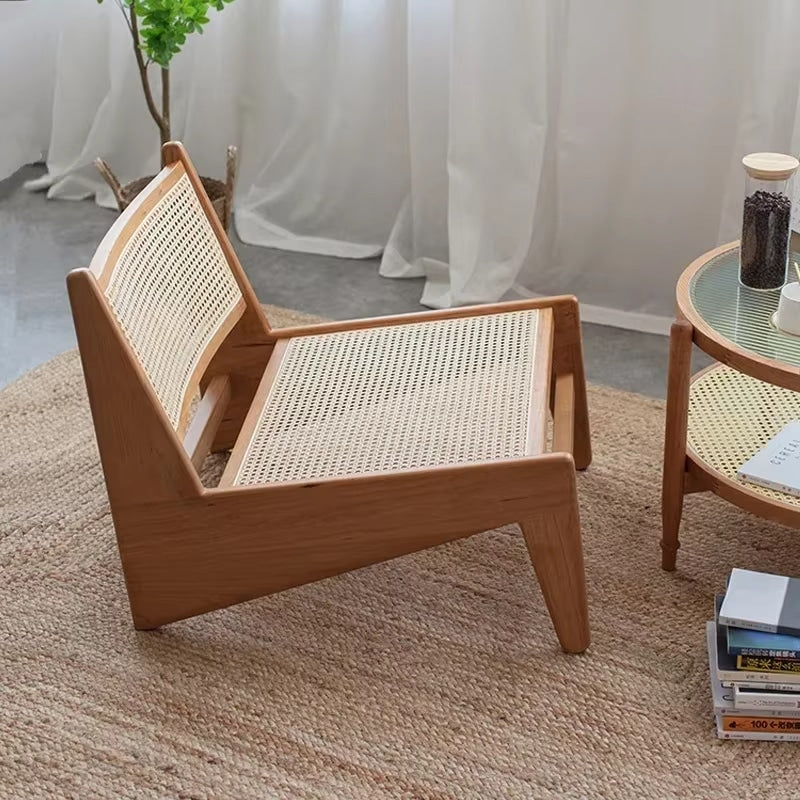 Low enveloping Nordic chair hand woven in natural beige wicker