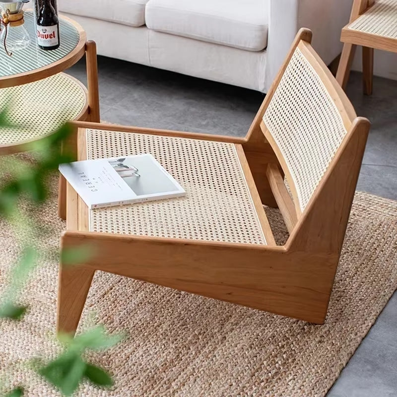 Low enveloping Nordic chair hand woven in natural beige wicker