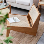Low enveloping Nordic chair hand woven in natural beige wicker