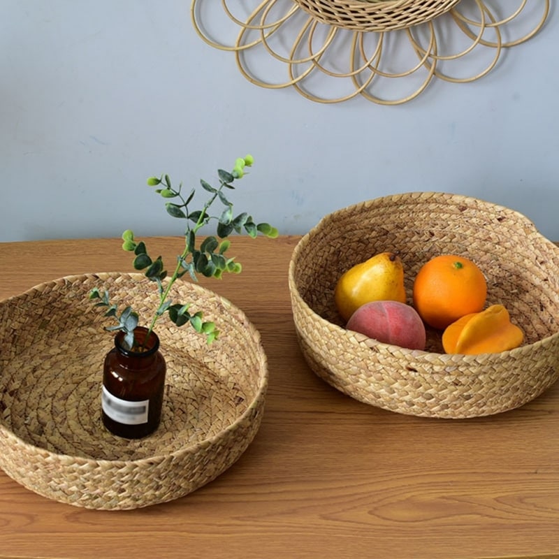 Low round woven basket filled with oranges