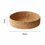 Low round woven basket filled with oranges