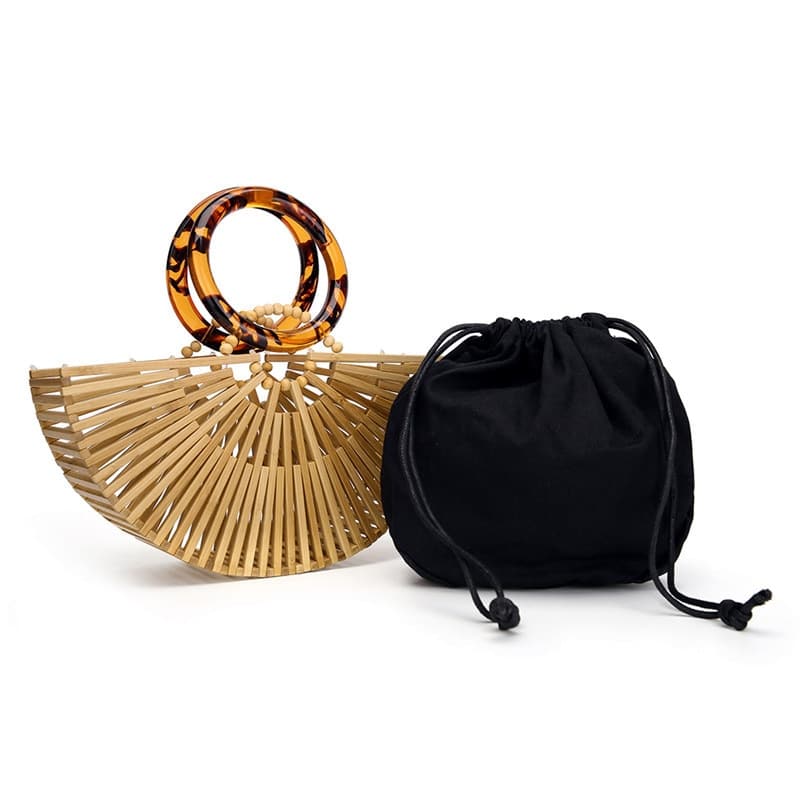 Structured handbag in sculpted natural wood with a hand woven rattan body