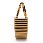 Structured handbag in sculpted natural wood with a hand woven rattan body