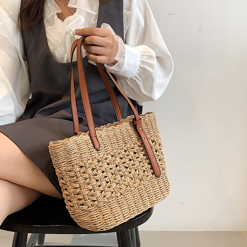Structured luxe handbag densely hand woven in straw in beige or brown
