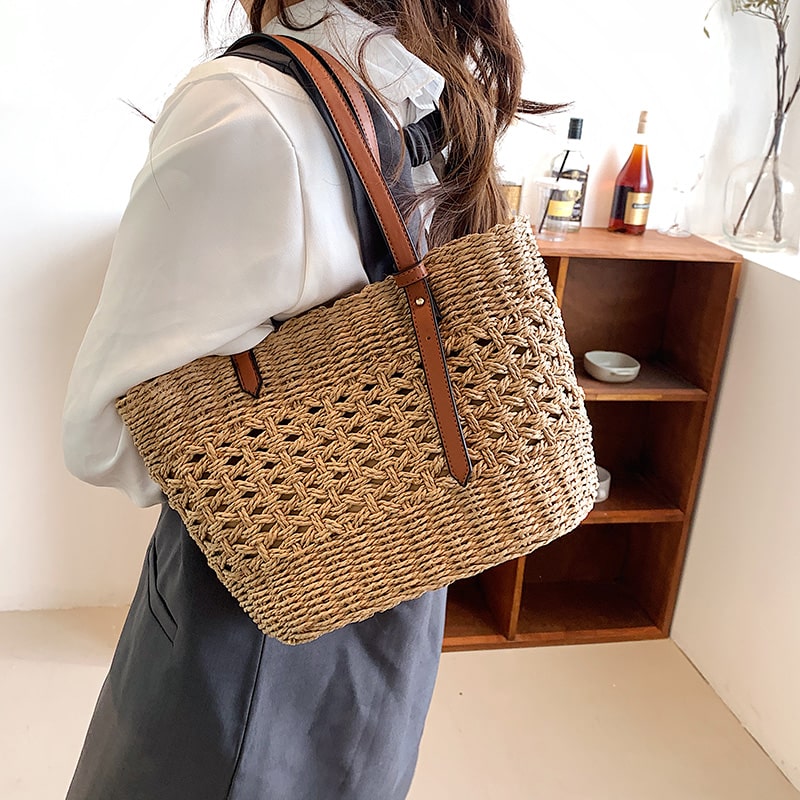 Structured luxe handbag densely hand woven in straw in beige or brown