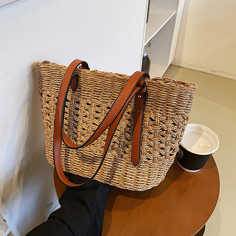 Structured luxe handbag densely hand woven in straw in beige or brown